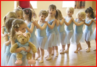 Image of a line of pre-school dancers holding the teddy, Melody Bear