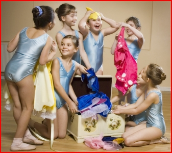 Photo of dancers with a dressing up box